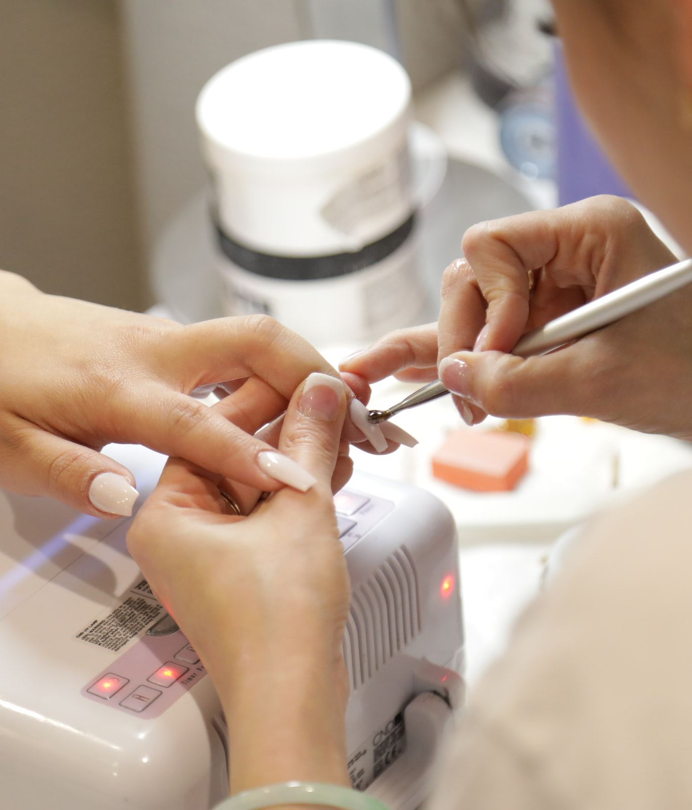 a beautician giving a nail manicure